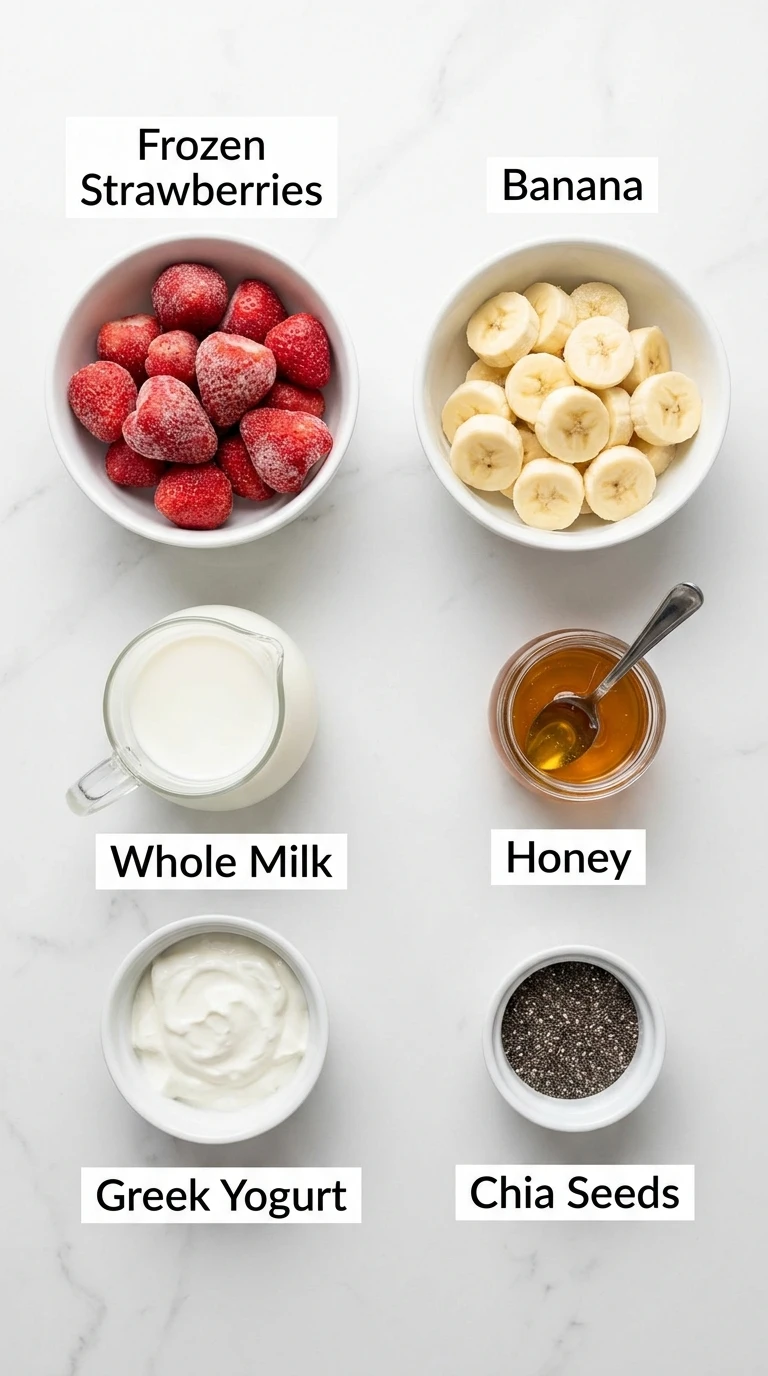 Flat-lay ingredients for a Strawberry Banana Smoothie Recipe: strawberries, banana, milk, yogurt, honey, chia seeds.