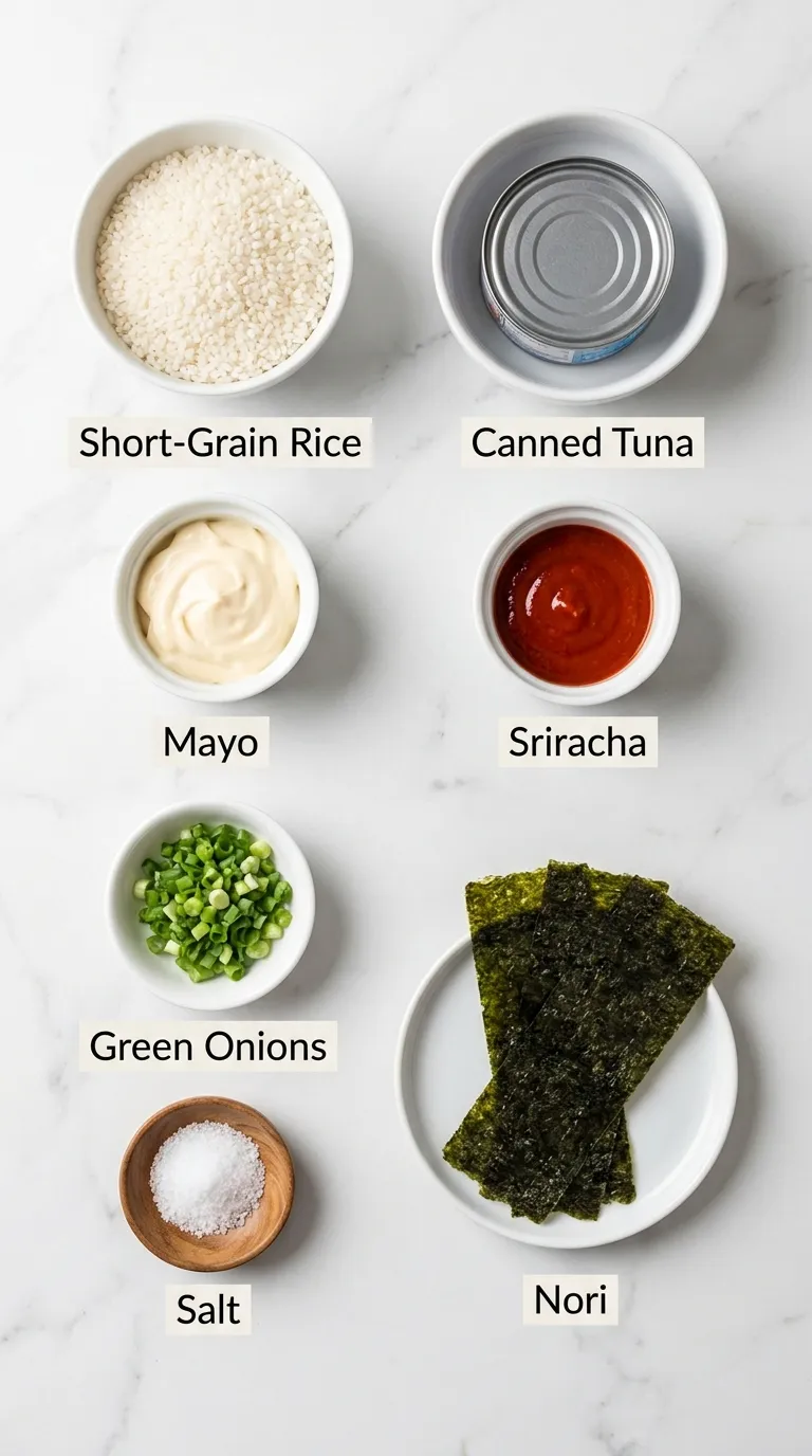 Labeled Tuna Onigiri Recipe ingredients neatly arranged in small bowls on a white marble countertop.